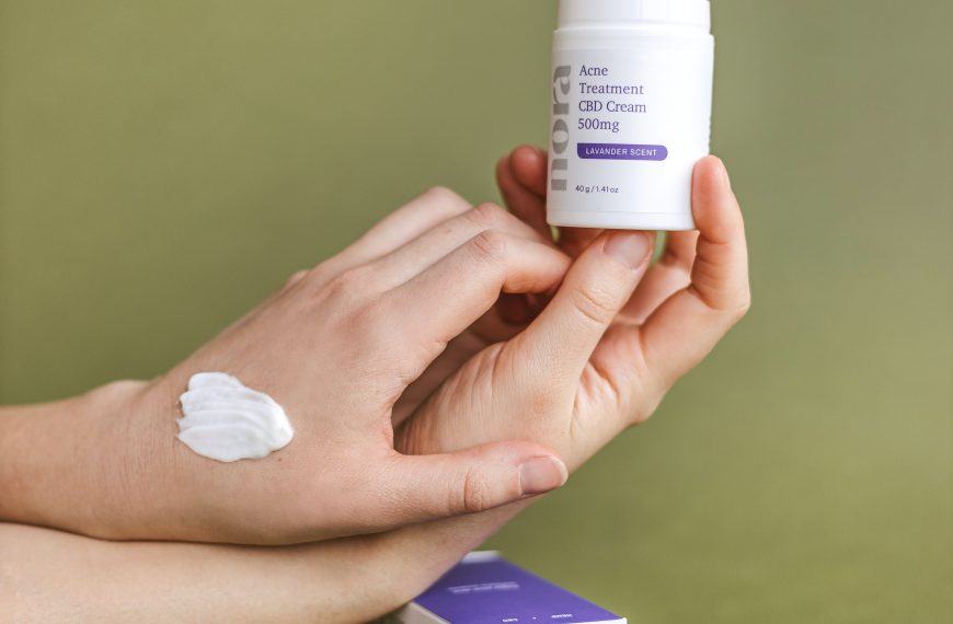 girl applying nora spot treatment on hand