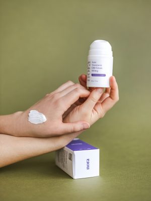 girl applying nora spot treatment on hand